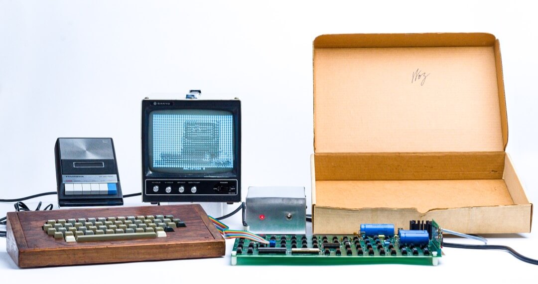 The Apple 1 computer with box, screen, keyboard, and circuit board displayed