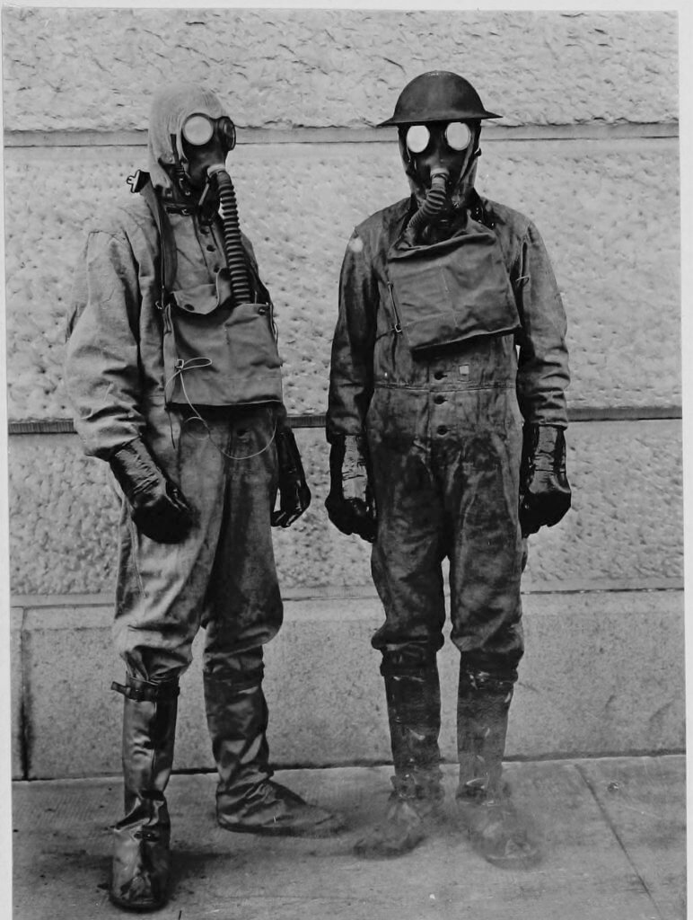 Two researchers wearing gas protection suits and masks, 1918